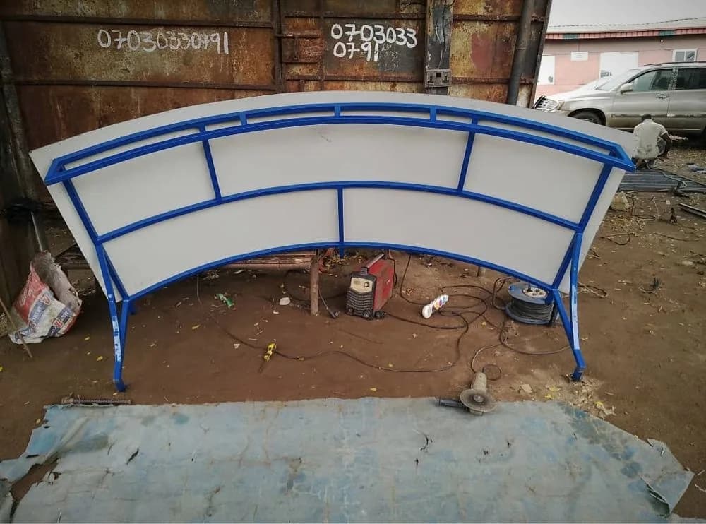 Curved steel frame fitted with panels, outside the Loyal Point workshop in Ketu