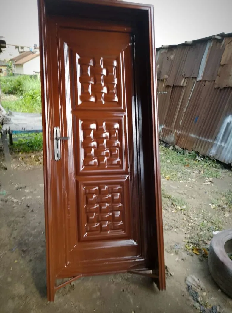 Glossy brown steel safety door with embossed panels and a chrome handle, made by Loyal Point Construction